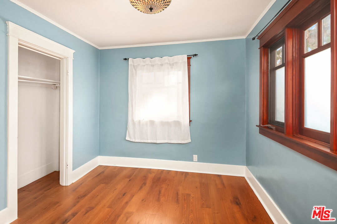 1436 Silver Boulevard Los Angeles, CA 90026 - Photo 19 of 31 an empty room with wooden floor and windows