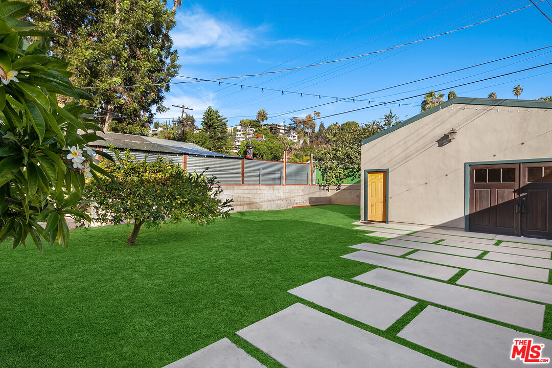 1436 Silver Boulevard Los Angeles, CA 90026 - Photo 23 of 31 a view of a backyard with couches plants and large tree