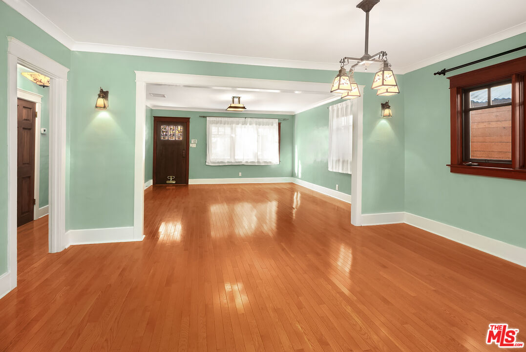 1436 Silver Boulevard Los Angeles, CA 90026 - Photo 8 of 31 a view of an empty room with window and wooden floor