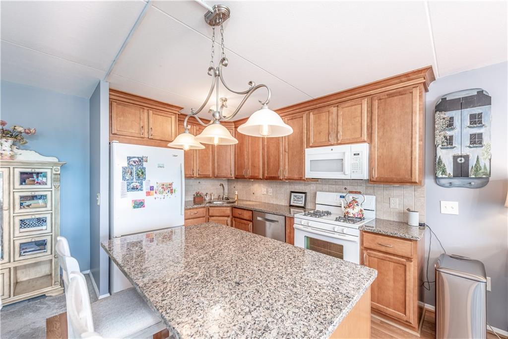 1150 Bower Hill Road, Unit 510B Pittsburgh, PA 15243 - Photo 13 of 25 a kitchen with stainless steel appliances granite countertop a sink stove and refrigerator