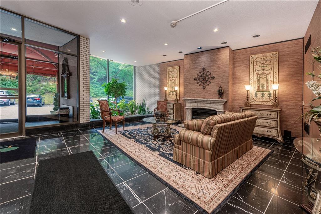 1150 Bower Hill Road, Unit 510B Pittsburgh, PA 15243 - Photo 3 of 25 a living room with furniture large window and a fireplace