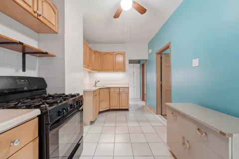 a kitchen with a stove a sink and a refrigerator