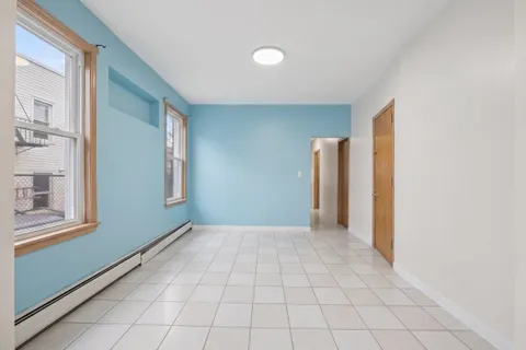 a view of a livingroom with an empty space and a window