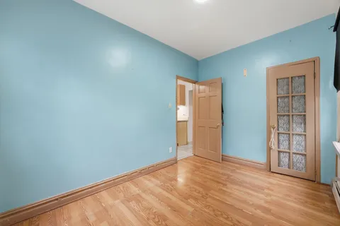 an empty room with closet and wooden floor
