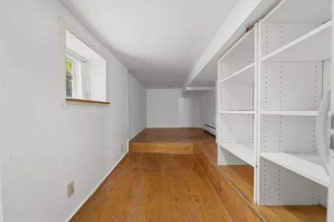 a view of a room with wooden floor