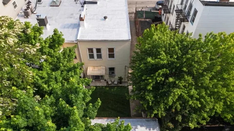 an aerial view of a house with a yard and garden