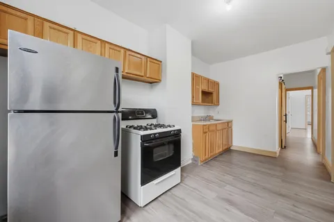 a kitchen with stainless steel appliances a refrigerator and a stove top oven