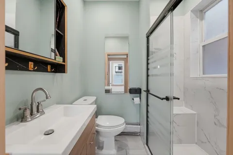 a bathroom with a sink toilet and shower