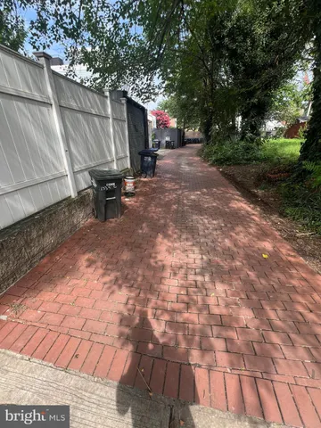 a view of a backyard with table and chairs and a large tree