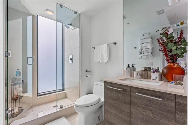 a bathroom with a sink toilet and shower
