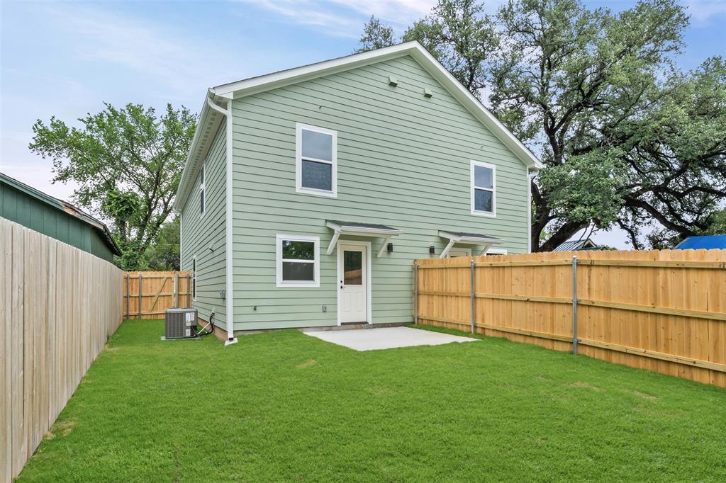 1536 Alexander Avenue, Unit A & B Waco, TX 76708 - Photo 8 of 30 Expansive backyard featuring a manicured lawn and a concrete patio