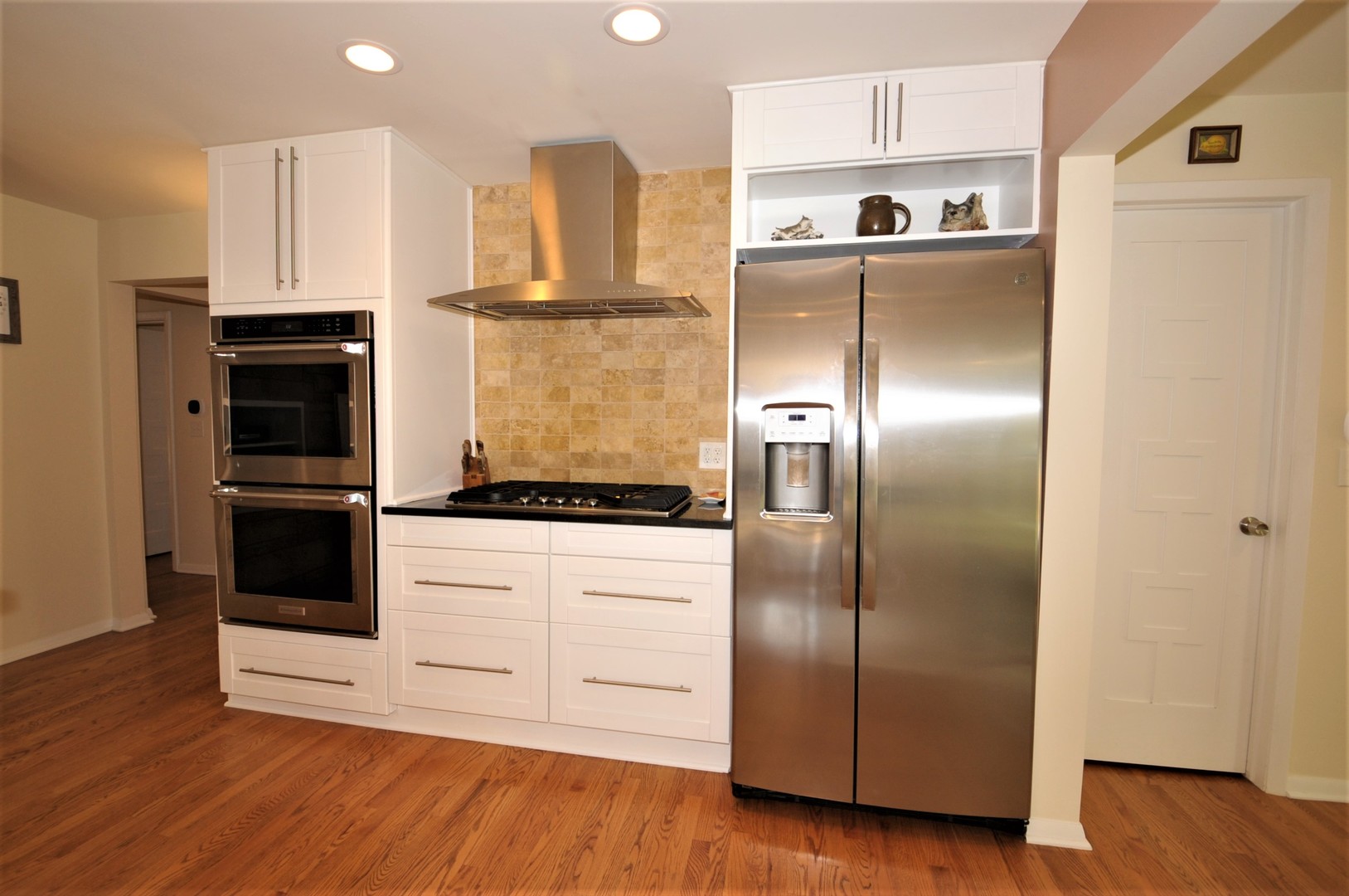 425 Maple Lane Geneva, IL 60134 - Photo 17 of 48 a kitchen with stainless steel appliances kitchen island granite countertop a refrigerator and a stove top oven