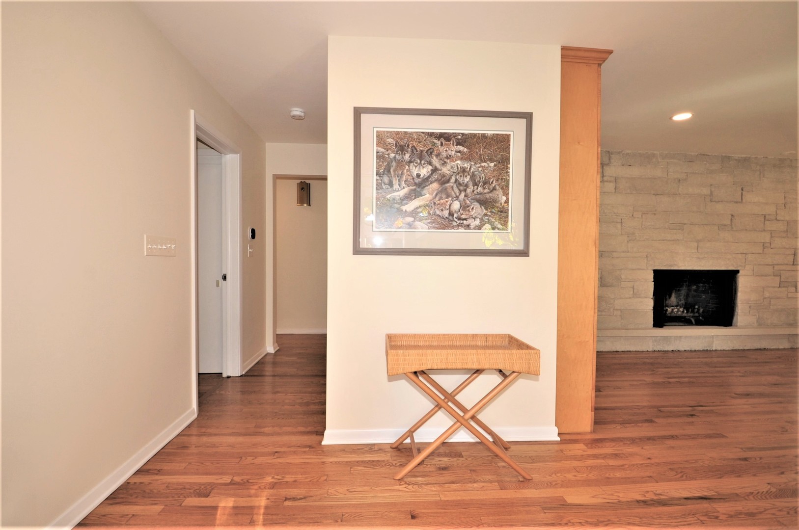425 Maple Lane Geneva, IL 60134 - Photo 10 of 48 a view of a hallway with wooden floor and a fireplace