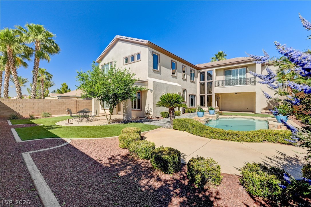 2793 Rosenhearty Drive Henderson, NV 89044 - Photo 3 of 85 This two-story residence boasts an inviting backyard with a pristine pool and a charming second-story balcony.
