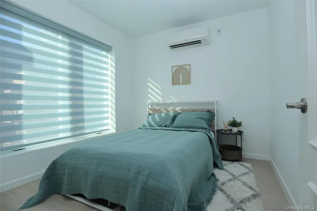 a bed sitting in a bedroom next to a window