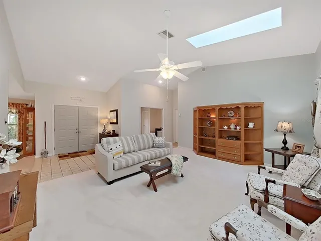 a spacious bedroom with a bed dresser and a window