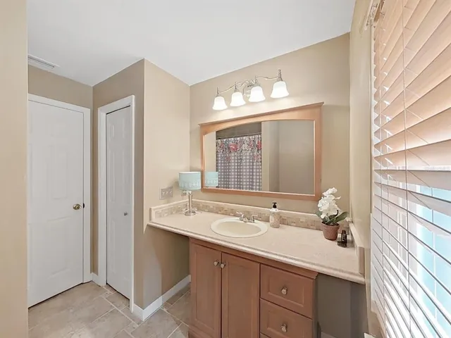 a kitchen with stainless steel appliances granite countertop a refrigerator a stove and a sink