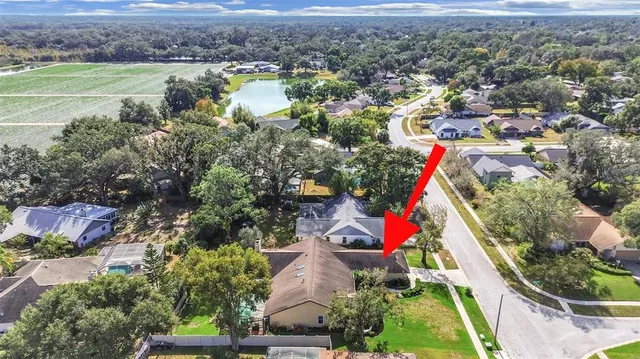 an aerial view of residential houses with outdoor space and swimming pool