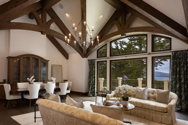 a living room with furniture a chandelier and a large window