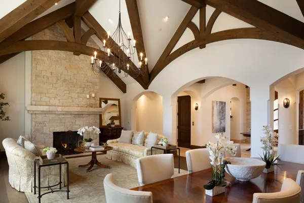 a living room with couches a fireplace with wooden floor
