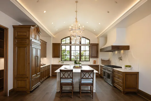a large kitchen with a table and chairs