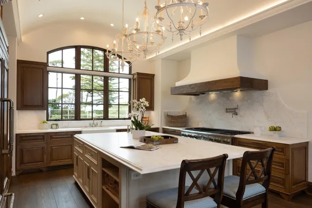 a kitchen with a table chairs sink and cabinets