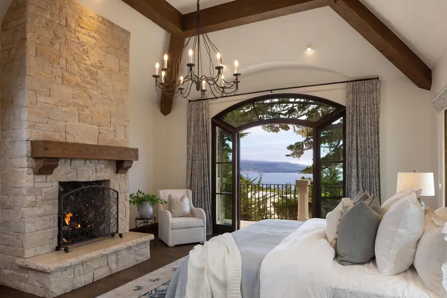 a bedroom with a fireplace a bed and a fireplace