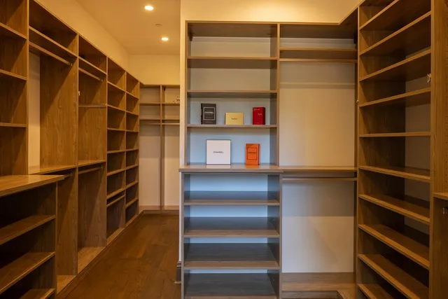 a view of walk in closet with empty racks