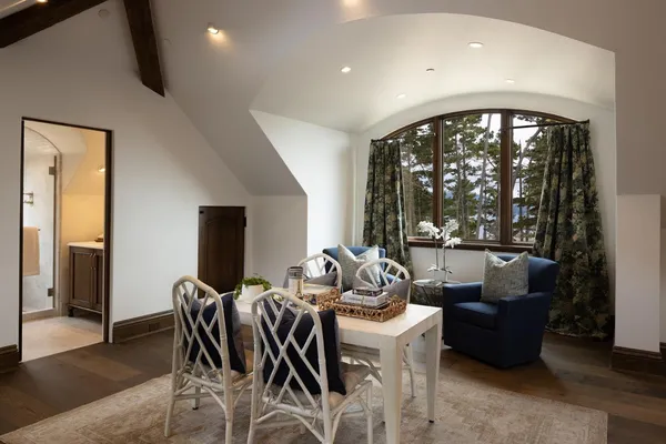 a dining room with furniture and a large window