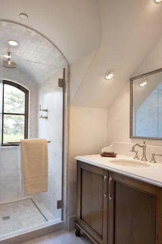 a bathroom with a sink a mirror and a window