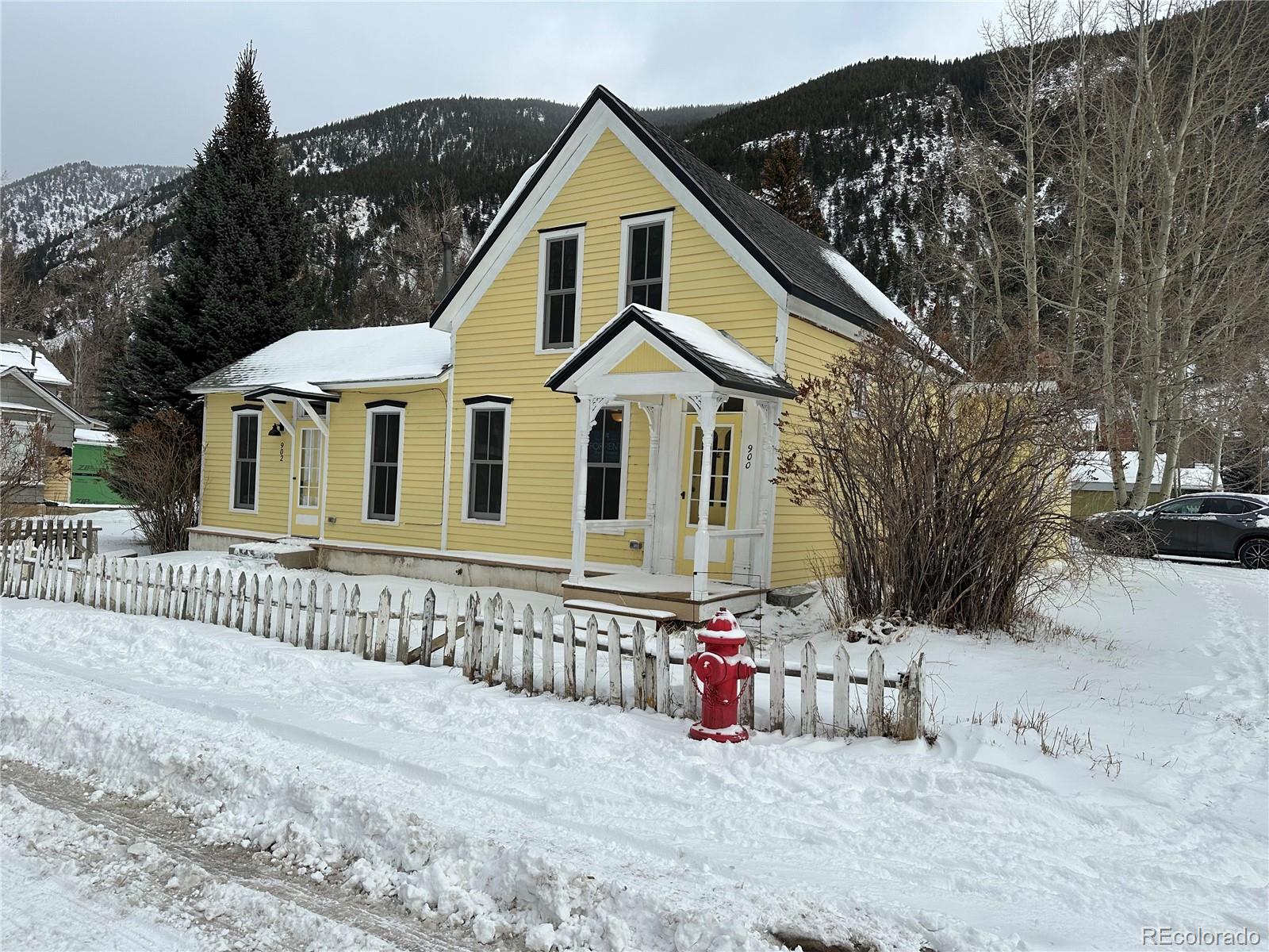 a view of a house with wooden fence