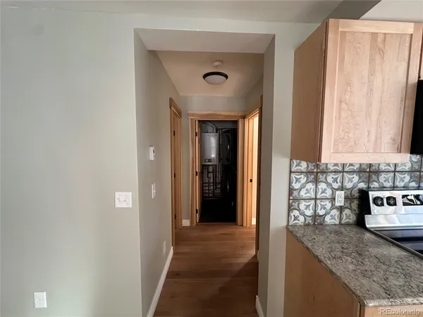 a view of a kitchen cabinets a counter top space and a window