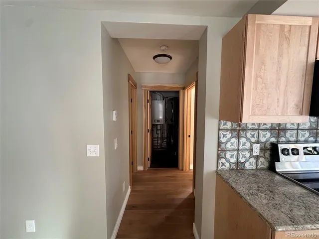 a view of a kitchen cabinets a counter top space and a window
