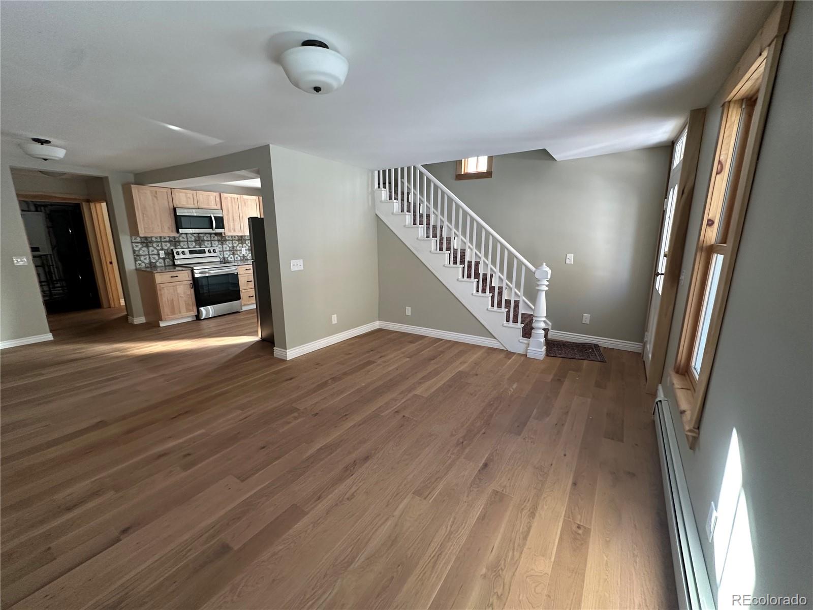 900 Rose Street Georgetown, CO 80444 - Photo 3 of 23 a view of a hallway with wooden floor and staircase