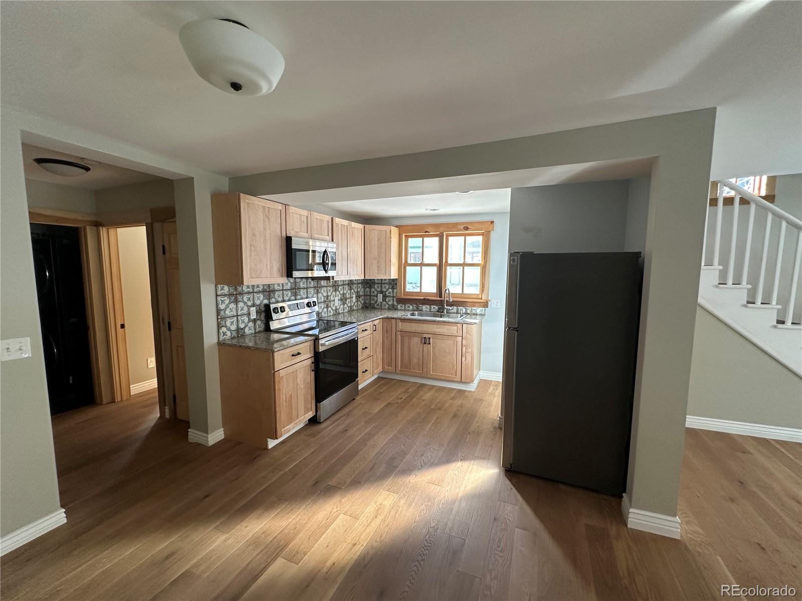 900 Rose Street Georgetown, CO 80444 - Photo 5 of 23 a kitchen with a refrigerator and a stove top oven