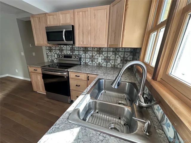 a kitchen with a stove a sink and a microwave