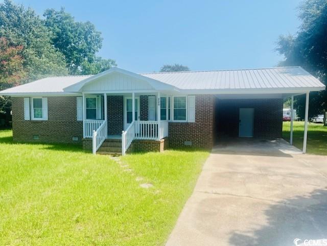 Ranch-style home featuring crawl space, a front lawn, driveway, and covered porch
