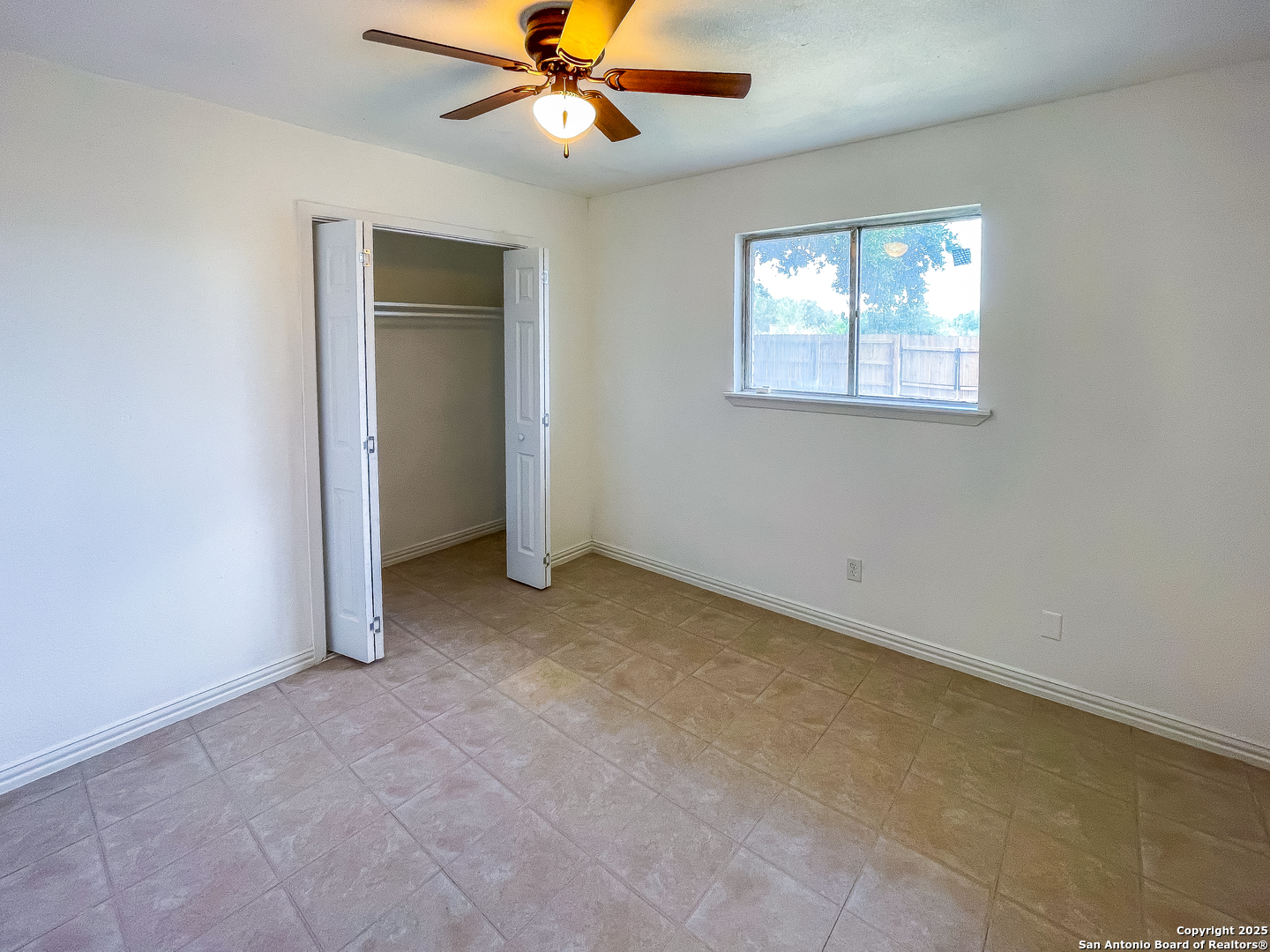 1206 Fairview Drive Beeville, TX 78102 - Photo 8 of 20 an empty room with windows and fan