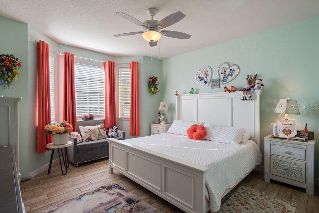 302 Terrace Ridge Circle, Unit 302 Davenport, FL 33896 - Photo 11 of 23 a bedroom with a bed and a chandelier
