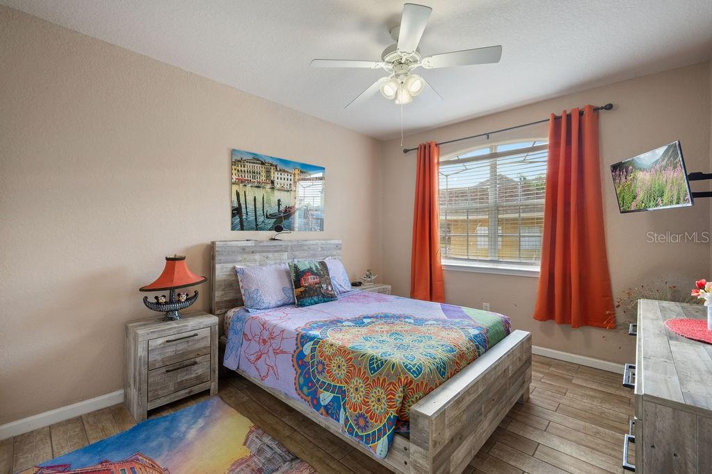 302 Terrace Ridge Circle, Unit 302 Davenport, FL 33896 - Photo 14 of 23 a bedroom with a bed and a chandelier