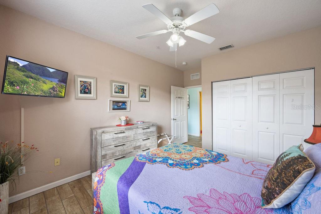 302 Terrace Ridge Circle, Unit 302 Davenport, FL 33896 - Photo 15 of 23 a bedroom with a bed and a chandelier