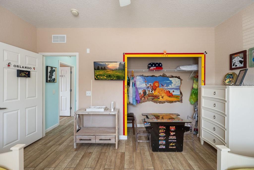 302 Terrace Ridge Circle, Unit 302 Davenport, FL 33896 - Photo 18 of 23 a view of a workspace with furniture and wooden floor