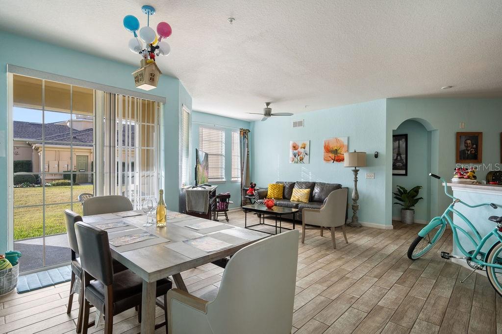 302 Terrace Ridge Circle, Unit 302 Davenport, FL 33896 - Photo 5 of 23 a view of a dining room with furniture window and wooden floor