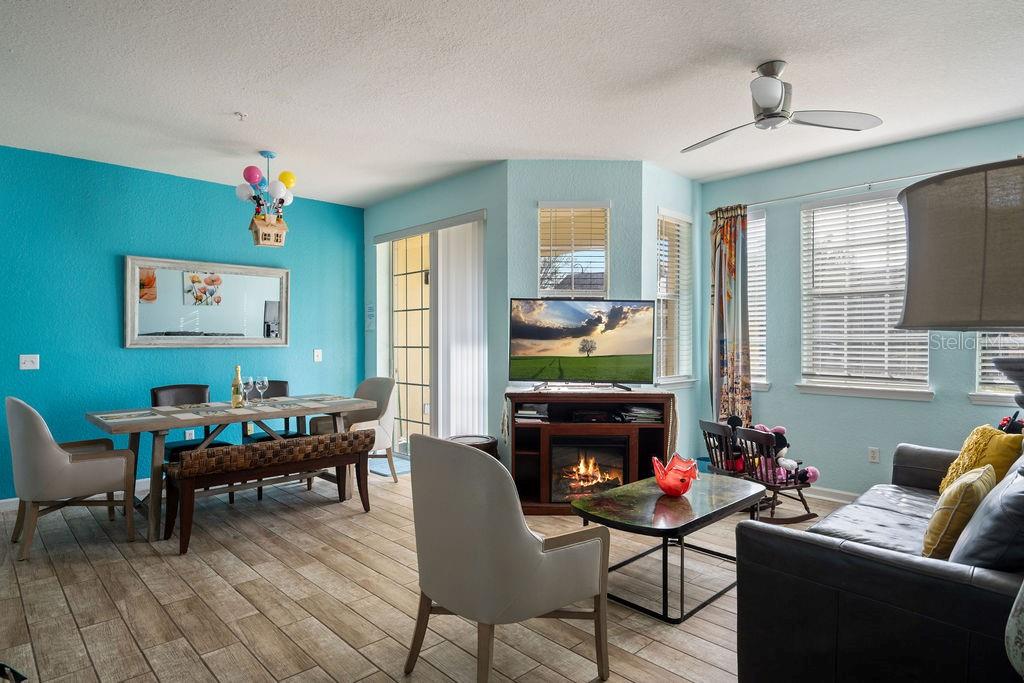 302 Terrace Ridge Circle, Unit 302 Davenport, FL 33896 - Photo 6 of 23 a living room with furniture a window and a fireplace