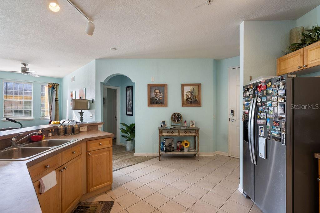 302 Terrace Ridge Circle, Unit 302 Davenport, FL 33896 - Photo 10 of 23 a kitchen with stainless steel appliances granite countertop a refrigerator and a sink