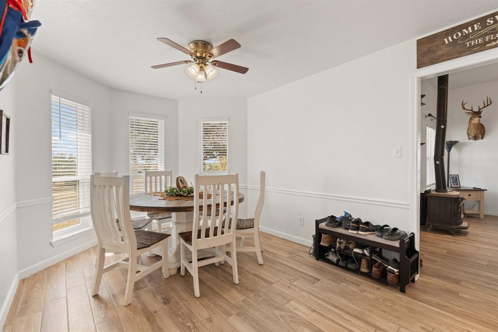 1013 Highland Road Cleburne, TX 76033 - Photo 11 of 33 a view of a dining room with furniture and wooden floor