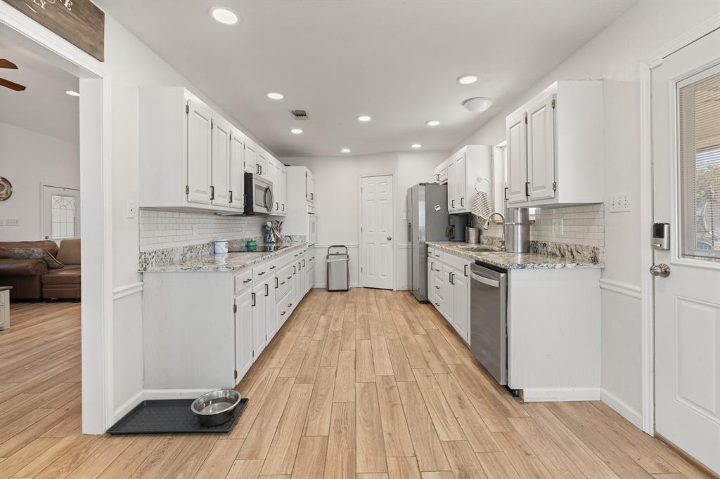 1013 Highland Road Cleburne, TX 76033 - Photo 12 of 33 a kitchen with stainless steel appliances a refrigerator sink and cabinets