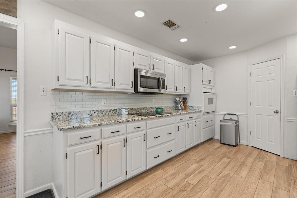 1013 Highland Road Cleburne, TX 76033 - Photo 13 of 33 a kitchen with sink cabinets and stainless steel appliances