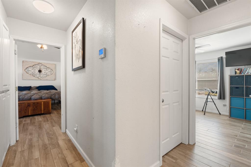 1013 Highland Road Cleburne, TX 76033 - Photo 15 of 33 a view of a hallway and a livingroom with wooden floor