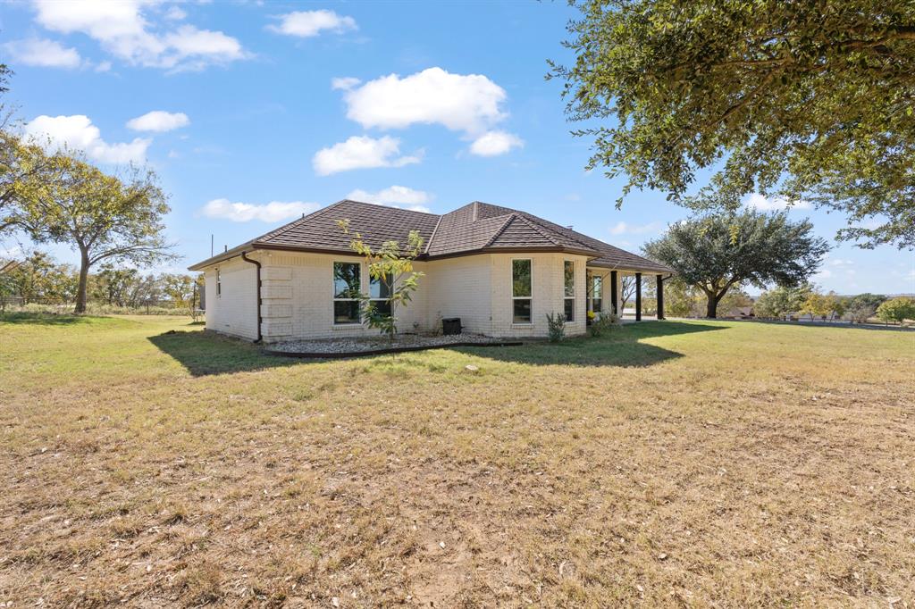 1013 Highland Road Cleburne, TX 76033 - Photo 2 of 33 a view of a house with a yard